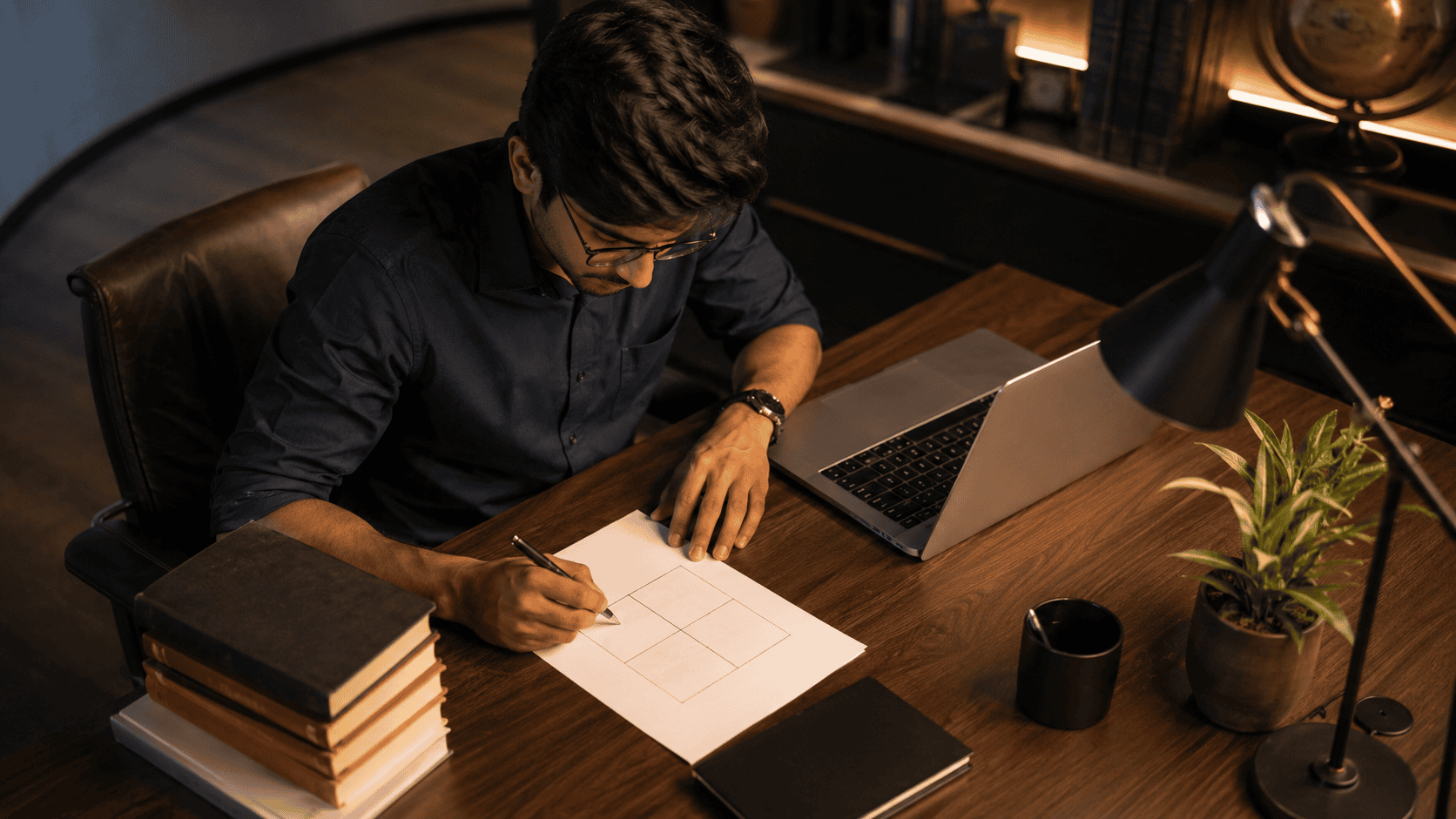 Business strategist sketching a 2x2 SWOT grid on paper at a desk